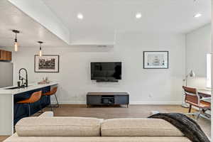 Medium wood type flooring in living room