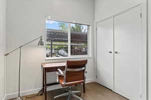 Living room flows into office space with large storage closet