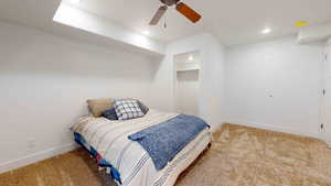 Bedroom with ceiling fan, a closet, carpet flooring, and a spacious closet