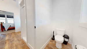 Bathroom featuring hardwood / wood-style floors and toilet