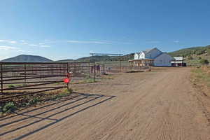 View of yard with a rural view and a mountain view