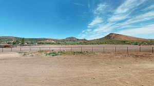 View of yard with a rural view and a mountain view