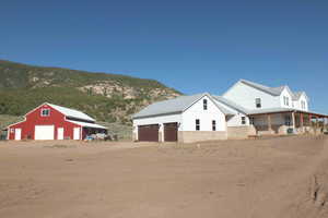 Exterior space featuring an outdoor structure, a mountain view, and a garage