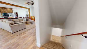 Staircase with light hardwood / wood-style floors