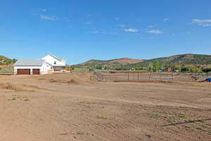 View of yard with a mountain view and a rural view