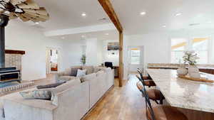 Living room featuring light hardwood / wood-style floors and a wood stove