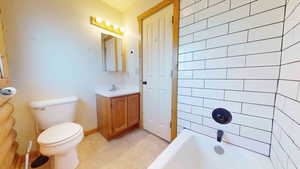 Full bathroom with tile flooring, shower / bathing tub combination, toilet, and vanity