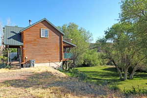 View of property exterior with a lawn