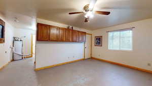 Interior space with ceiling fan and water heater