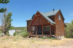 View of front of home with a shed