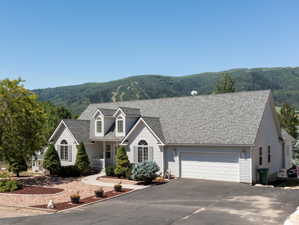 View of front of house with a garage and a mountain view