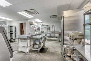Kitchen with stainless steel counters and concrete floors