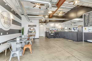 Dining room featuring ceiling fan and concrete flooring