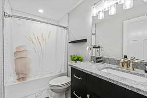 Full bathroom featuring tile flooring, shower / tub combo with curtain, toilet, and vanity