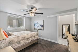 Bedroom with ceiling fan and carpet flooring