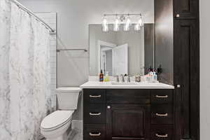 Bathroom with tile floors, vanity, and toilet