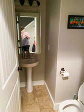 Bathroom with tile patterned floors and toilet