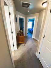 Hallway featuring carpet floors