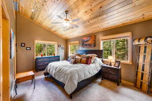 Bedroom featuring carpet flooring, wooden ceiling, ceiling fan, and vaulted ceiling