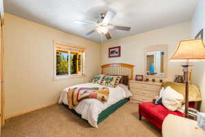 Carpeted bedroom with ceiling fan