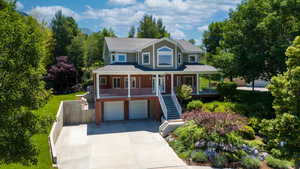 View of front of property with a garage and covered porch