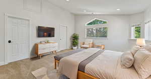 Carpeted bedroom with high vaulted ceiling and multiple windows