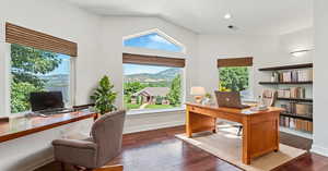 Office area featuring high vaulted ceiling and dark hardwood / wood-style flooring