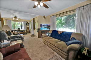 Living room with light carpet and ceiling fan