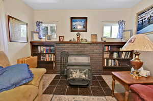 Tiled living room featuring a brick fireplace