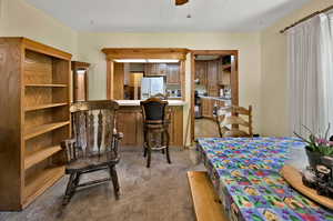 Carpeted dining space featuring sink