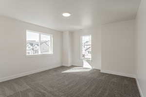 Carpeted empty room featuring a healthy amount of sunlight