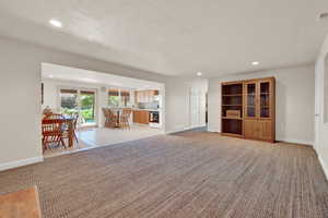 Unfurnished living room with light colored carpet