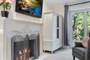 Interior space featuring light carpet and ornamental molding