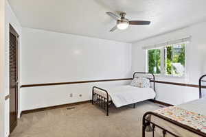 Carpeted bedroom with ceiling fan