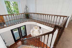 Stairway featuring a chandelier, french doors, and dark hardwood / wood-style flooring