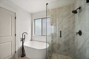 Bathroom featuring tile patterned flooring and a shower with door