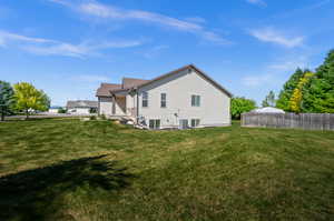 View of side of home featuring a yard