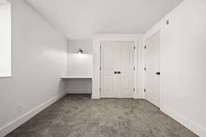 Unfurnished bedroom featuring a closet and carpet flooring