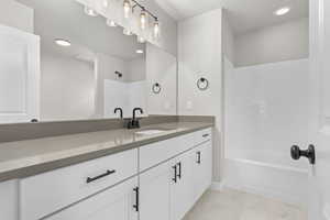 Bathroom featuring vanity and tub / shower combination