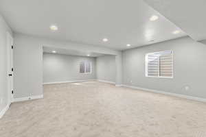 Carpeted spare room featuring a textured ceiling