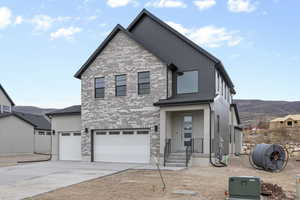 View of front of property featuring a mountain view and a garage