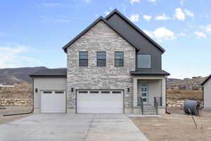 View of front of house featuring a mountain view and a garage