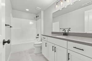 Full bathroom featuring vanity, toilet, and bathtub / shower combination