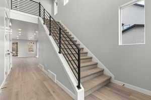 Stairway with hardwood / wood-style flooring