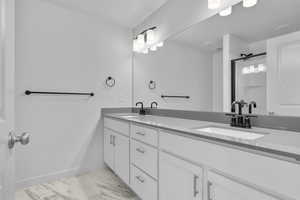 Bathroom with double vanity and tile patterned flooring