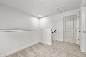 Walk in closet featuring light colored carpet