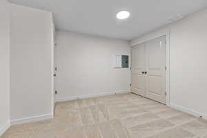 Carpeted spare room with electric panel