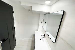 Bathroom featuring sink and tile patterned floors