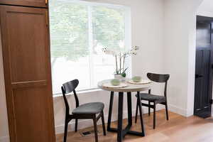 Dining area with light hardwood / wood-style flooring