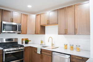 Kitchen with sink, tasteful backsplash, and stainless steel appliances